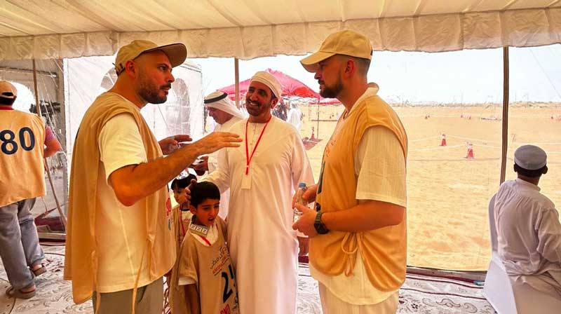 Conversation in a tent with desert background